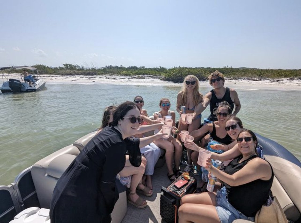 Group cheersing at the sandbar